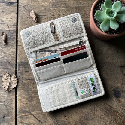 Handmade hemp wallet with purple, pink, and green floral embroidery in a sustainable, vegan tri-fold design