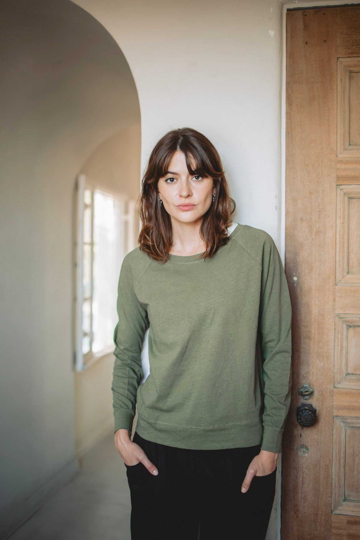 Women’s Hemp Jersey long-sleeve top in muted olive green jersey, with a crew neckline, raglan sleeves and banded hem.