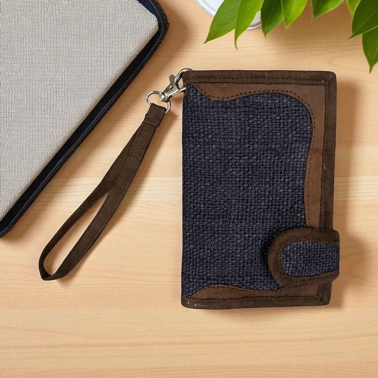 Handmade navy hemp wallet with brown trim and detachable wrist strap, eco-friendly and durable design