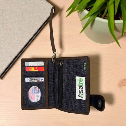Open wallet with cards on a wooden surface next to a plant