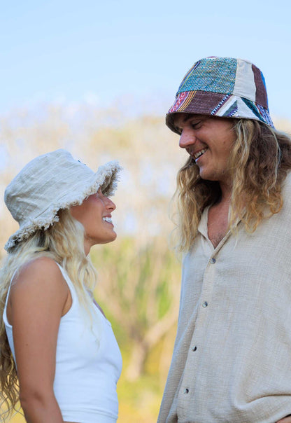 Hemp Linen Sun Hat in Neutral Stripe pattern, worn outdoors.