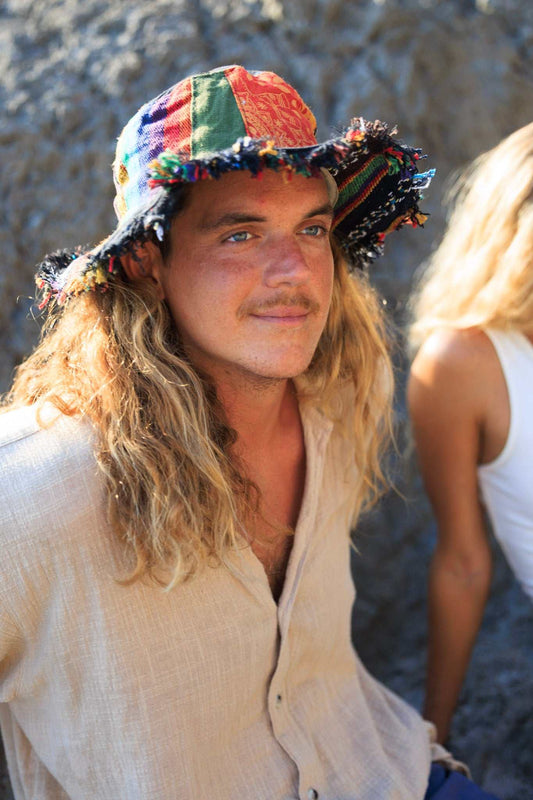 Hemp patchwork sun hat with wide brim, eco-friendly design worn by a person outdoors.