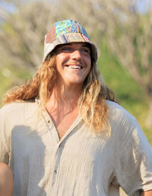 Hemp hat - eco-friendly patchwork bucket hat worn by a person outdoors.