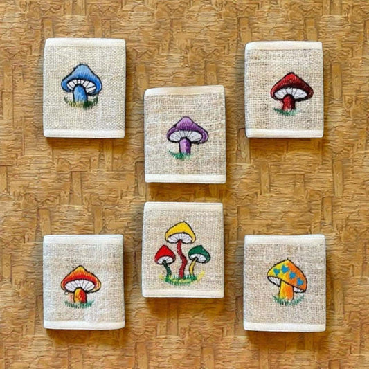 Eco-friendly hemp bi-fold wallets with colorful mushroom embroidery, handmade from durable hemp fabric.