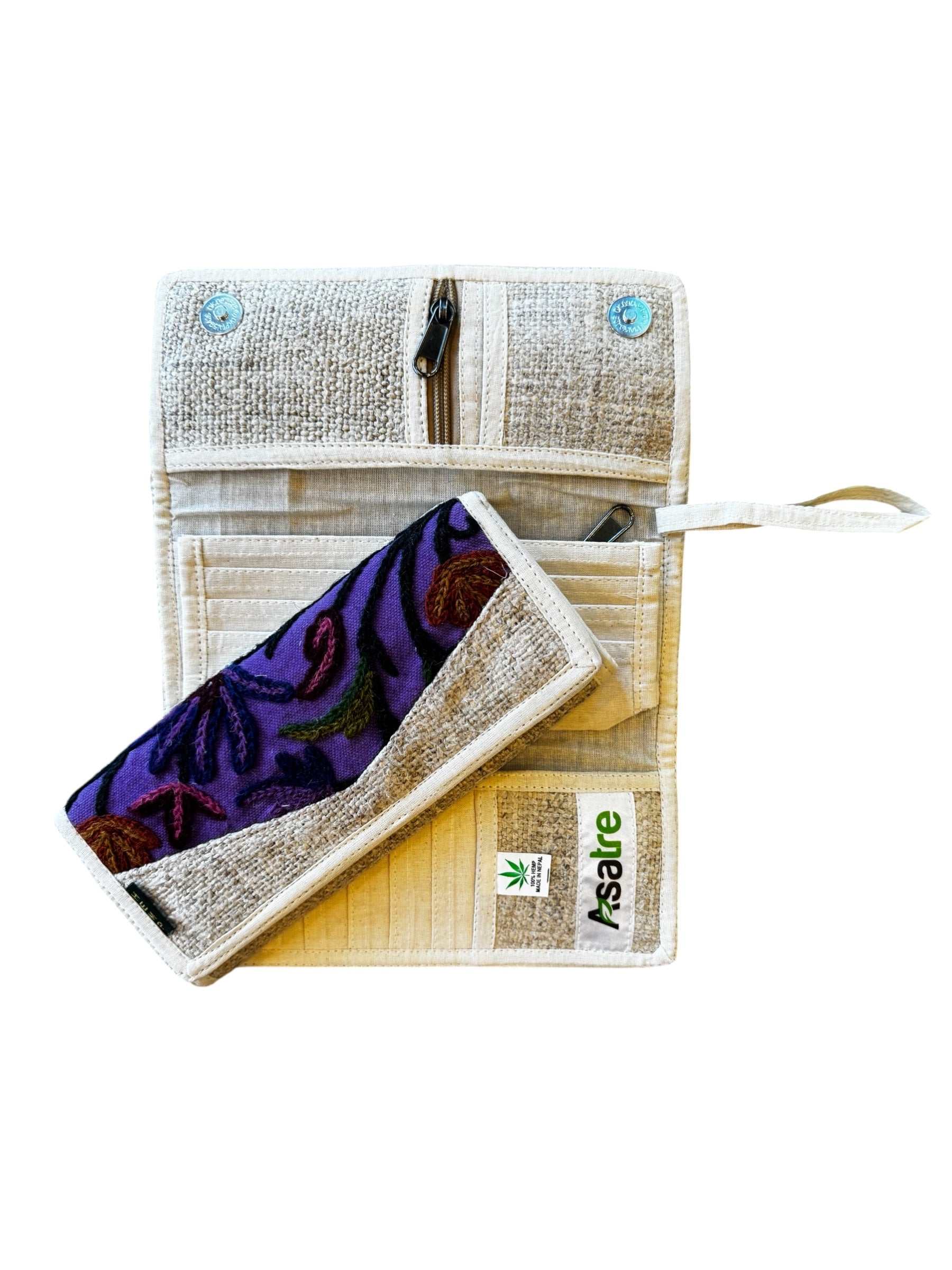 Handmade hemp wallet with purple, pink, and green floral embroidery in a tri-fold sustainable vegan design