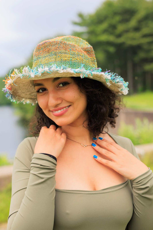 Woman wearing eco-friendly multi-color rainbow hemp hat with fringed brim outdoors