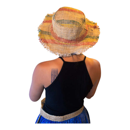 Person wearing a colorful straw hat on a white background