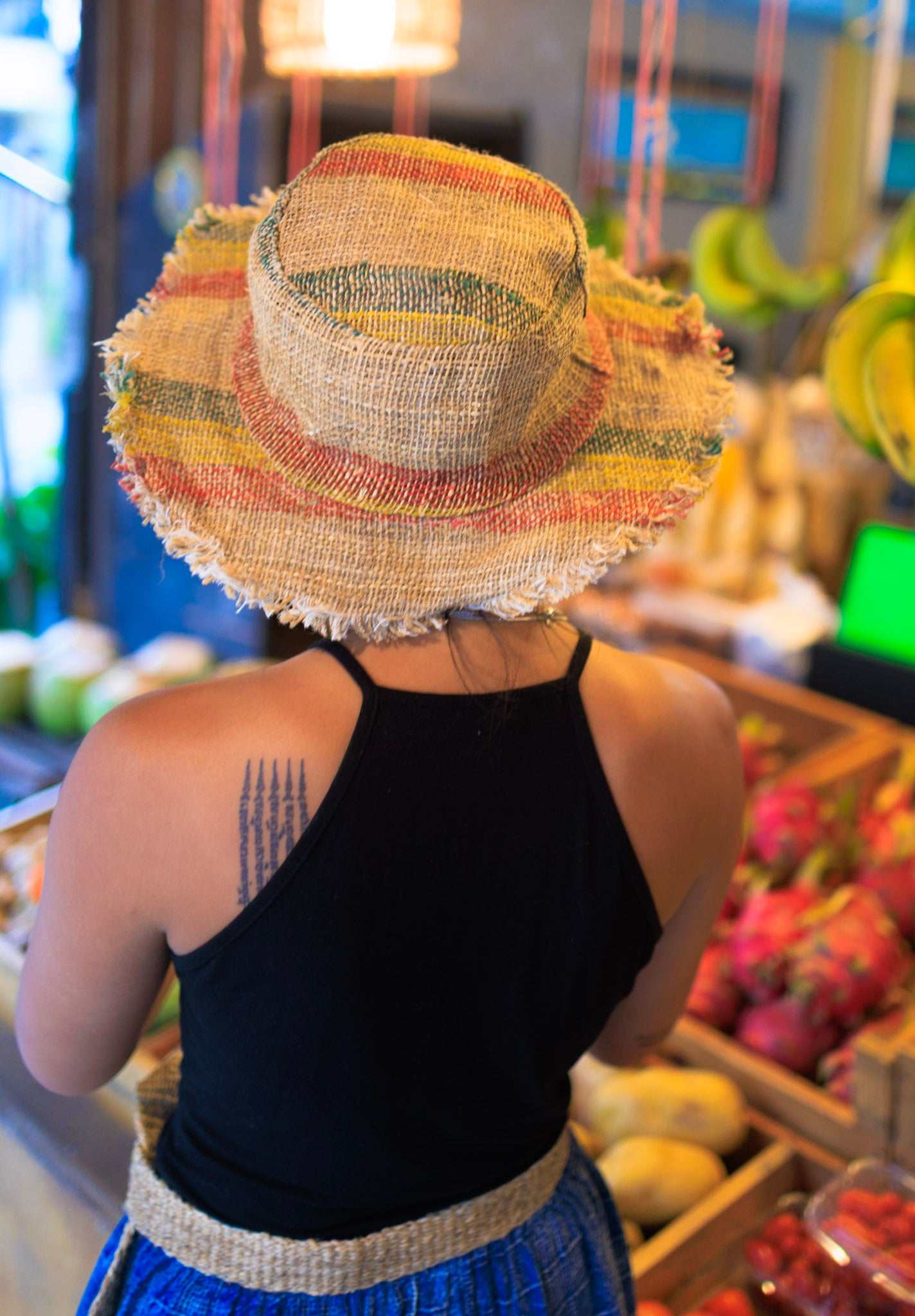 Handmade eco-friendly hemp sun hat with red, yellow, and green Rasta stripes and frayed brim