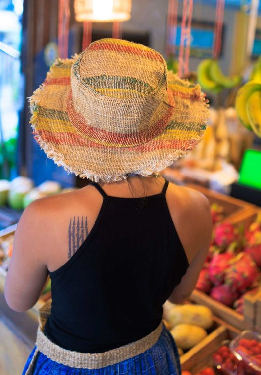 Handmade eco-friendly hemp sun hat with red, yellow, and green Rasta stripes and frayed brim