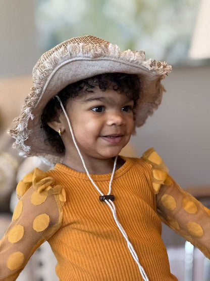 Toddler wearing eco-friendly hemp child sun hat with wide brim and chin strap