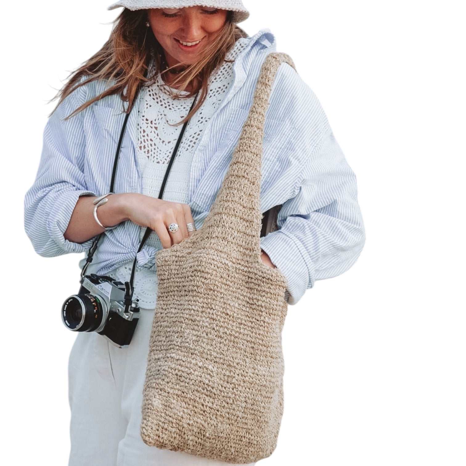 Handmade hemp shoulder bag with crochet design, natural beige color, and zipper closure for eco-friendly travel and market shopping