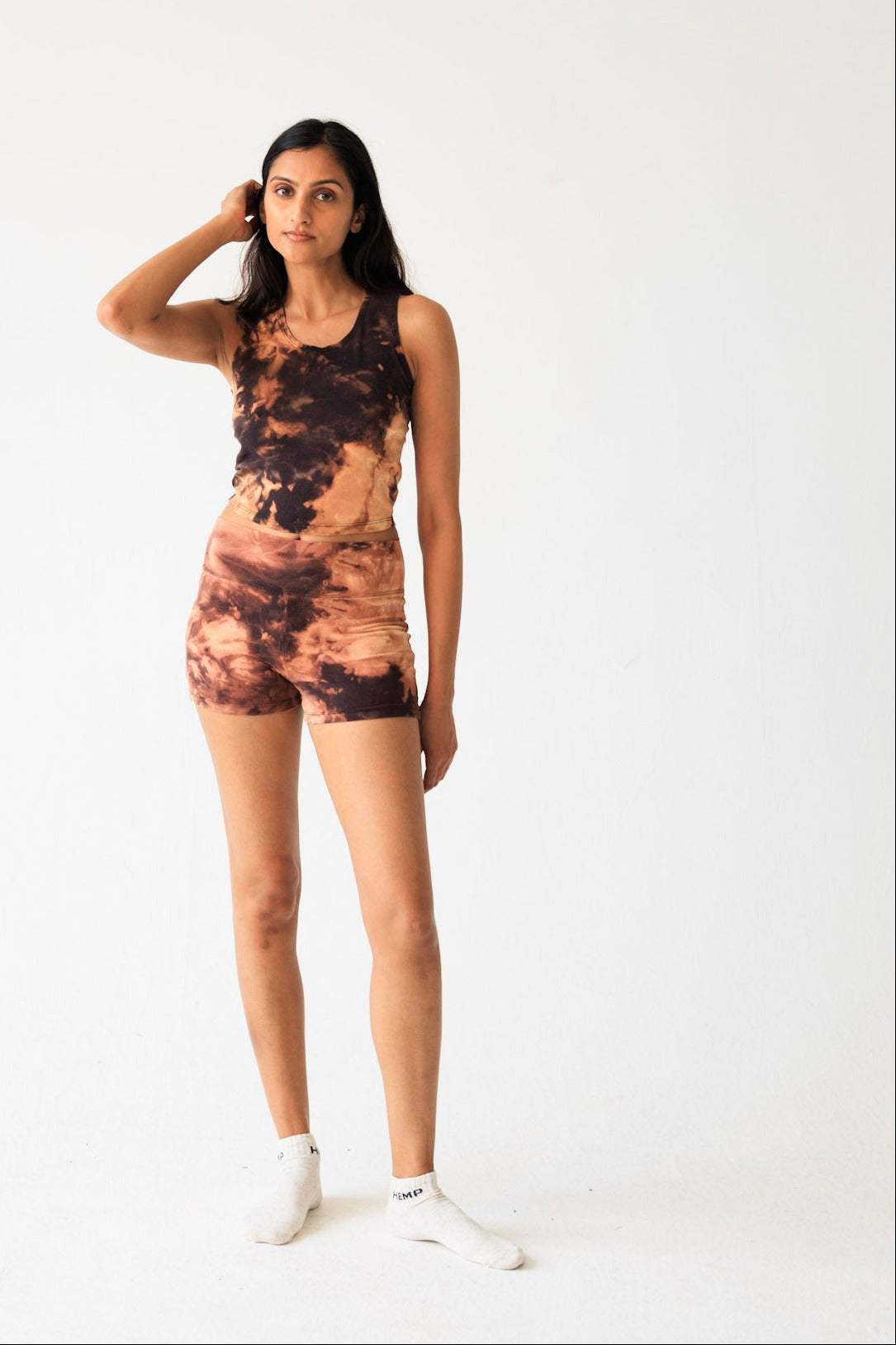 Woman wearing a tie-dye outfit on a white background