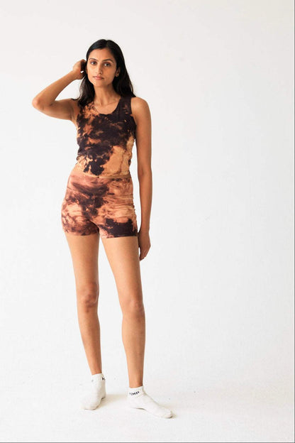 Woman wearing a tie-dye outfit on a white background