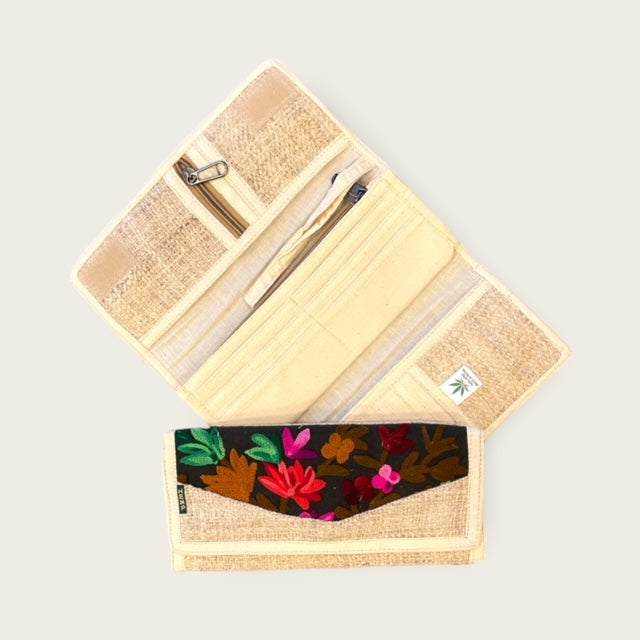 Eco-friendly women's hemp wallet with floral embroidery, showing tri-fold design and multiple compartments.