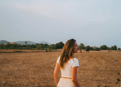 Cotton Crop Top in white, fitted with short sleeves and a cropped hem, worn with light-colored bottoms