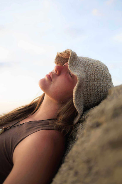 Hand-crocheted hemp floppy beach hat with wide brim and boho style