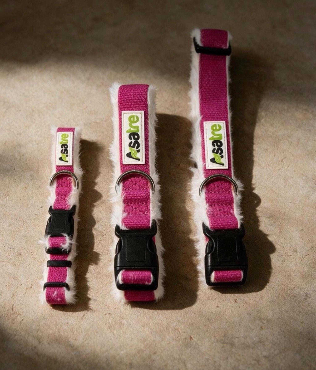 Hemp Dog Collar in vivid pink woven hemp with black plastic buckles, shown in three adjustable sizes with metal rings