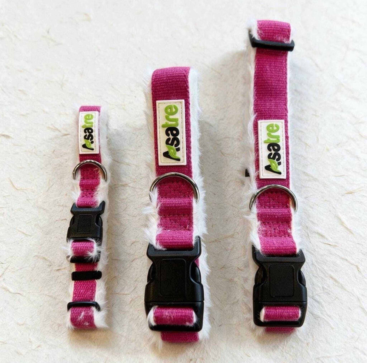 Hemp Dog Collar in bright pink woven webbing with white fleece lining, metal D-ring, and black plastic buckle