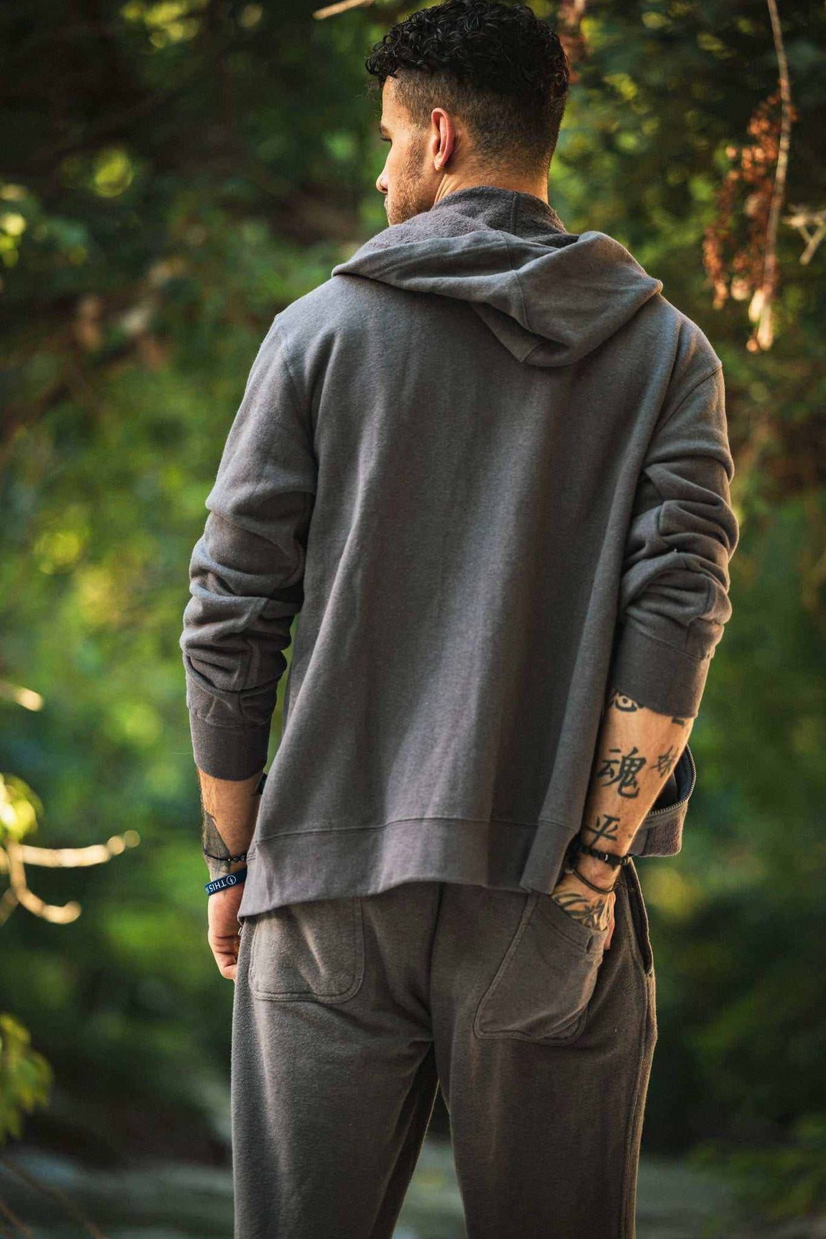 Hemp Hoodie in charcoal gray cotton-blend fabric, shown from behind with a hood, long sleeves, and ribbed cuffs