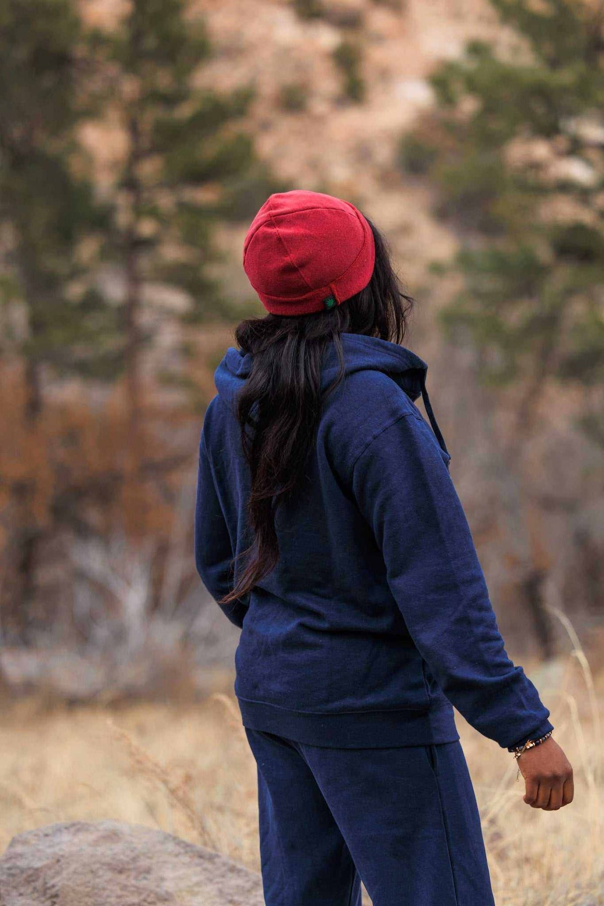 Hemp Hoodie in navy blue with a soft-looking fabric, worn with matching pants and a red knit beanie