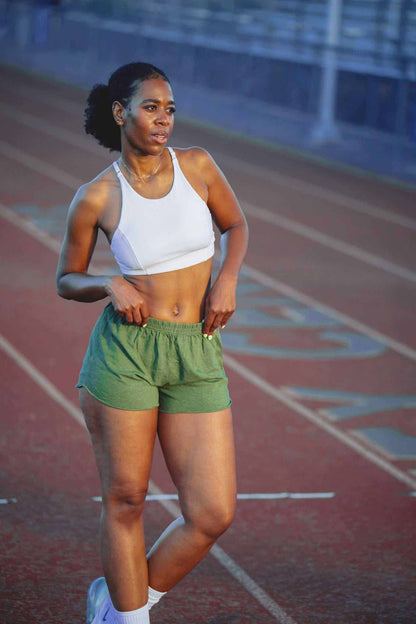Hemp running shorts in olive green jersey with an elastic waistband and relaxed fit, shown on an athlete