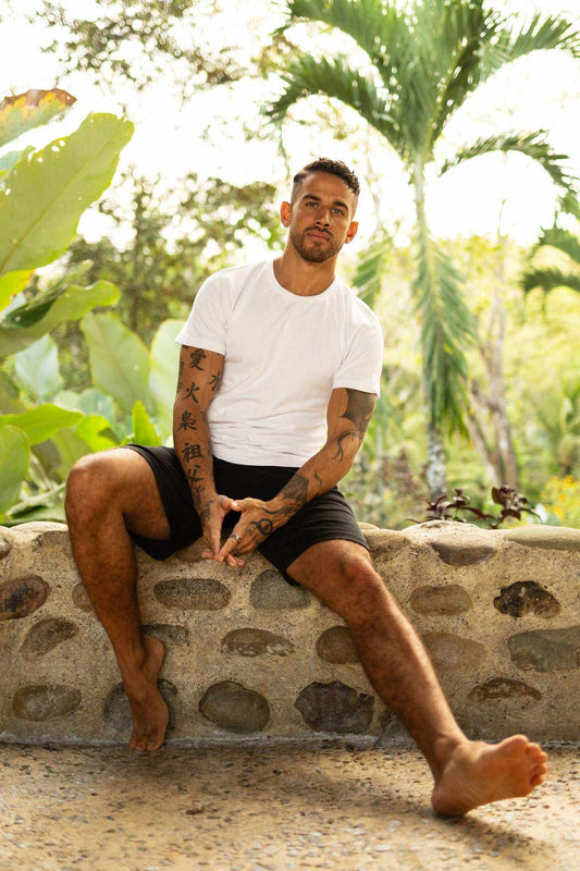 Hemp T-Shirt in plain white fabric, worn with black shorts; classic short sleeves and a crew neckline.