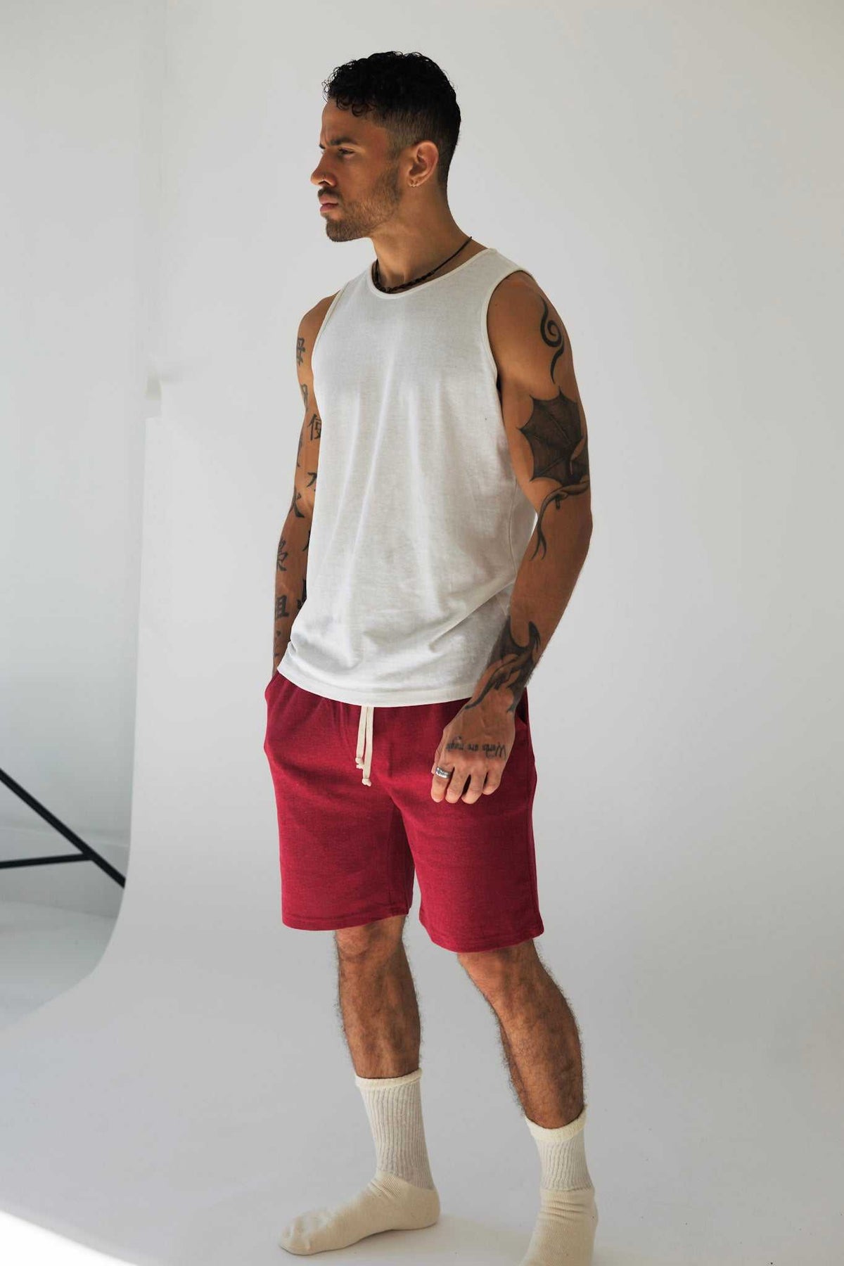 Hemp Tank Top in plain white sleeveless jersey with a classic muscle cut and wide armholes, worn with red shorts