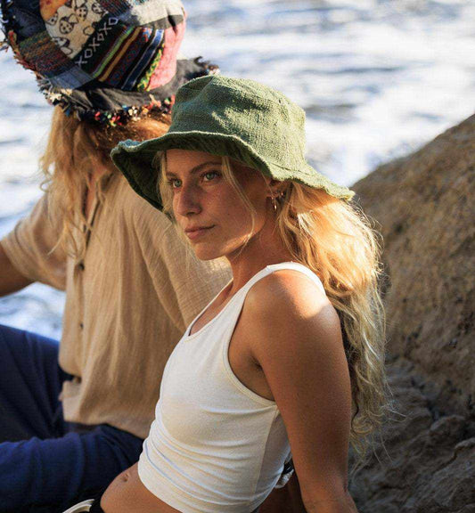 Hemp hat in olive, eco-friendly and unisex, worn by a woman outdoors.