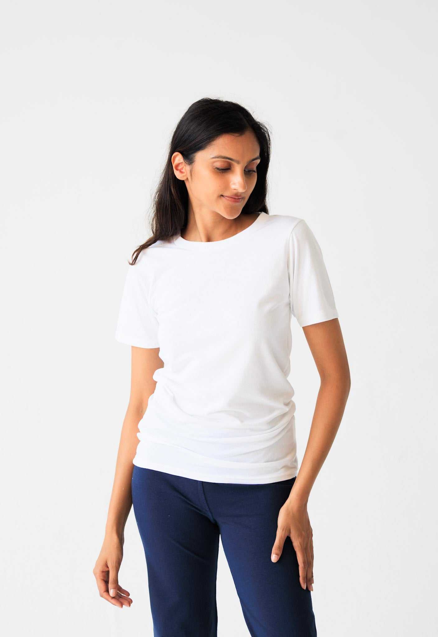 Woman wearing white hemp t-shirt in studio setting
