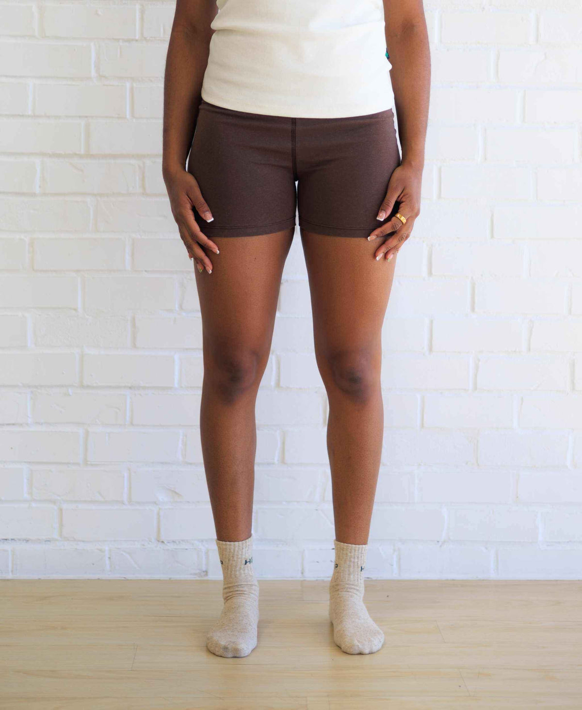 Women's Yoga Shorts in solid chocolate brown, featuring a smooth stretch fabric, fitted silhouette, and wide waistband