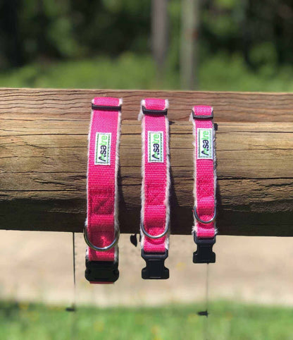 Hemp Dog Collar in bright pink hemp webbing, shown in three adjustable sizes with chrome D-rings and black buckles