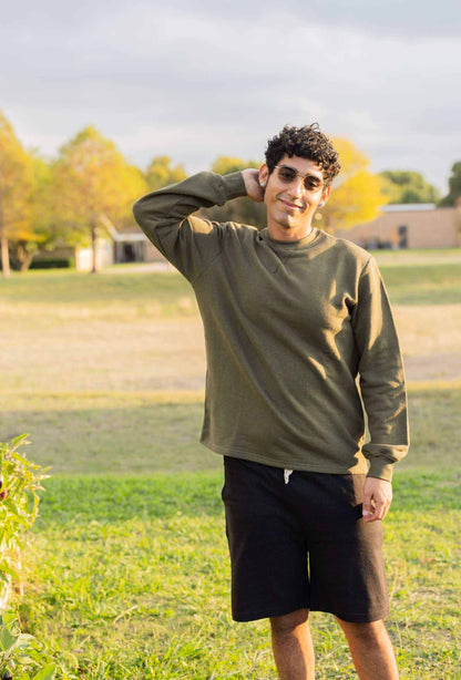 Man wearing olive green french terry sweatshirt outdoors