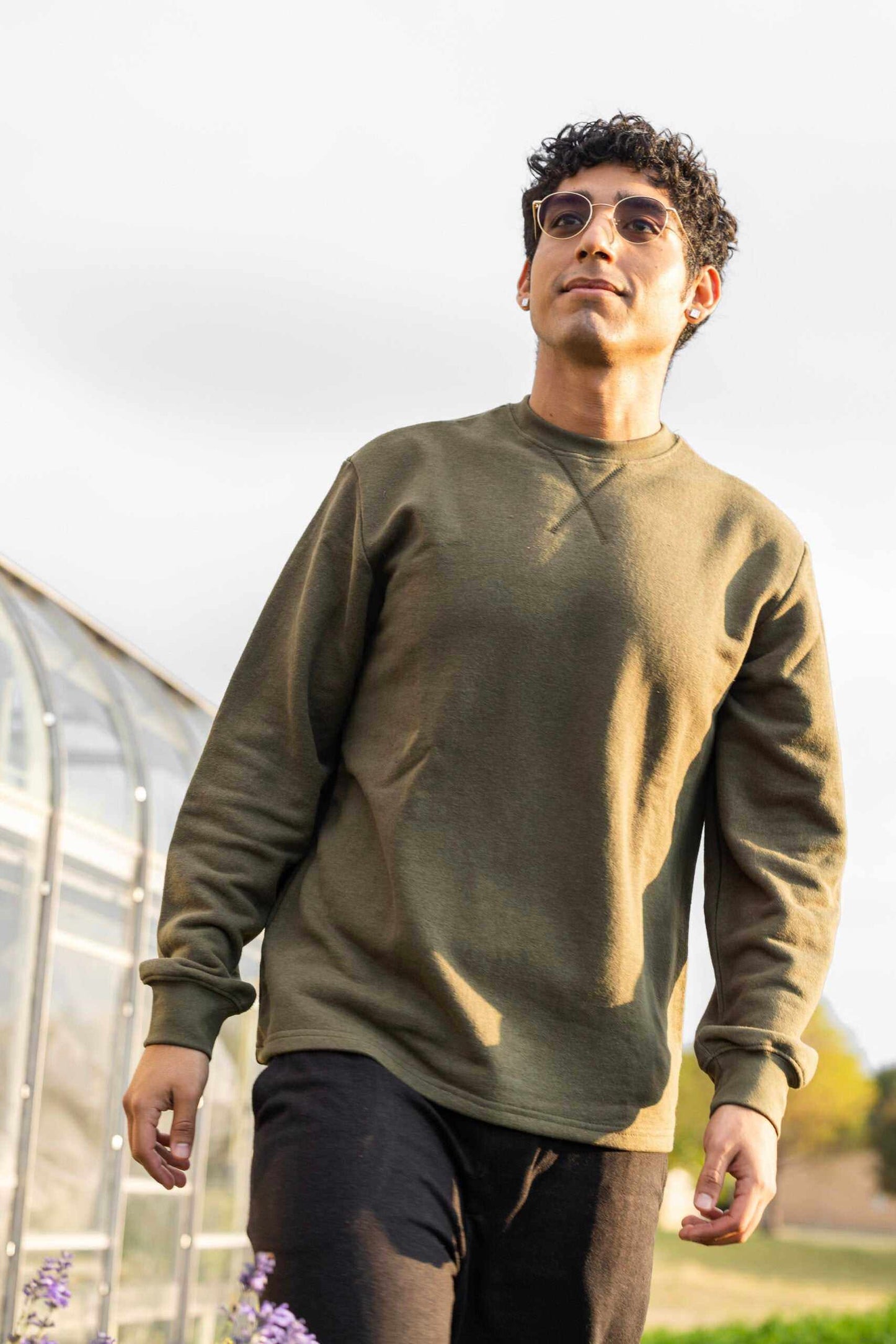 man wearing olive hemp terry sweatshirt outdoors unisex crew neck pullover