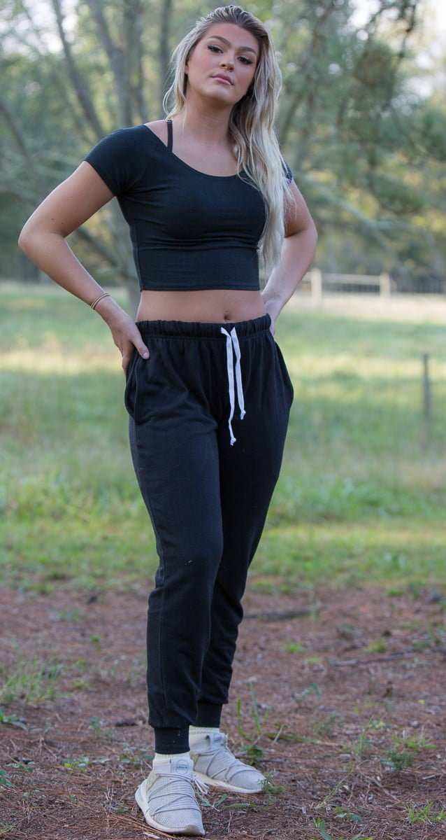 Woman wearing black hemp joggers with drawstring waist in outdoor setting