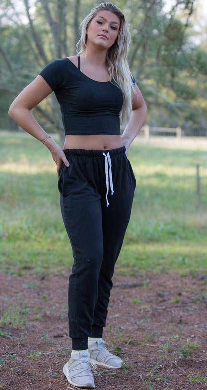 Woman wearing black hemp joggers with drawstring waist in outdoor setting